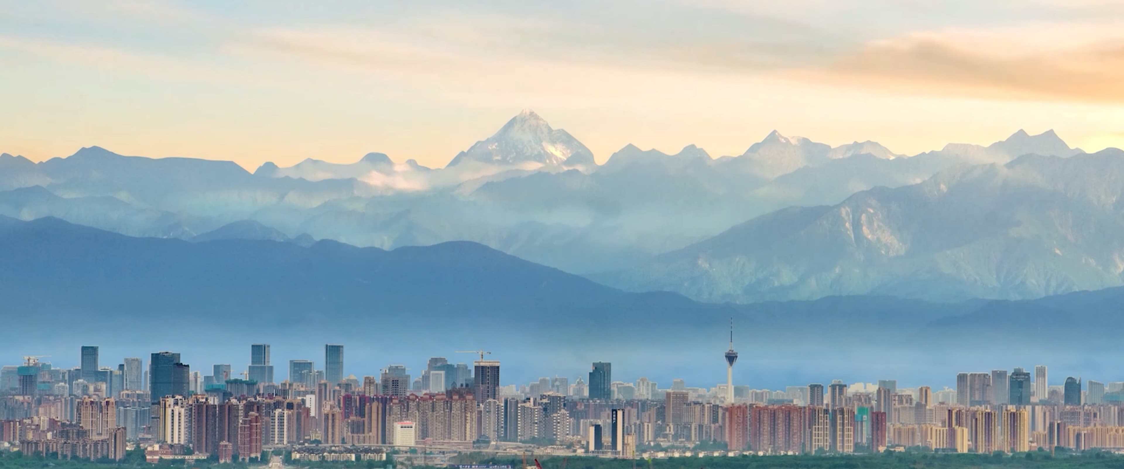 Chengdu skyline beneath the snow-capped mountains of Sichuan